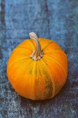 pumpkin on wooden background/big, ripe, orange pumpkin lies on the wooden background; food Raw foodists