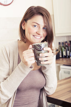 Beautiful brunette young woman drinking coffee