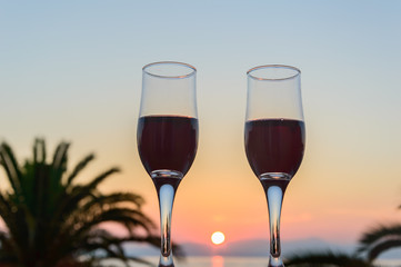 Glass of wine at sunrise at sea
