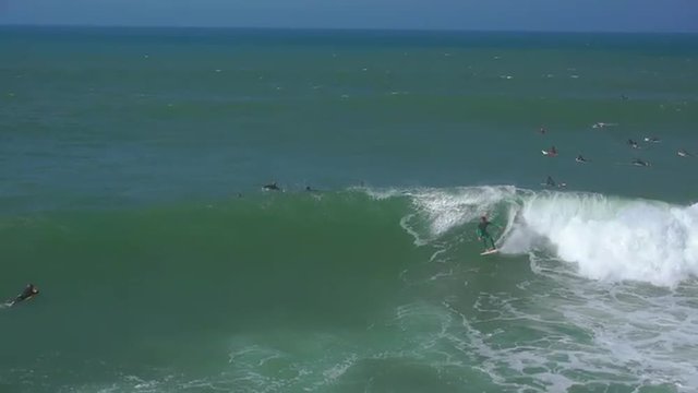 AERIAL: Surfer riding big wave