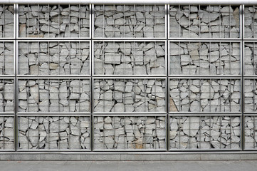 Modern stone wall, protected by a metal frame