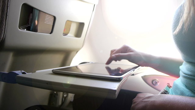 CLOSE UP: Using digital tablet on a plane