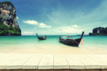 Fototapeta premium Empty top of wooden table or counter and view of tropical beach