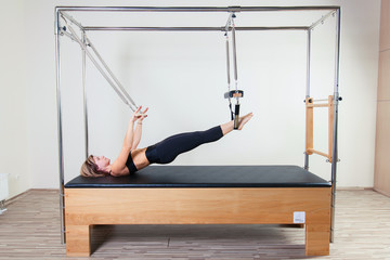 Pilates aerobic instructor woman in cadillac fitness exercise