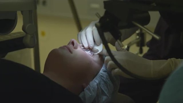 LASER EYE SURGERY STEP 2: Opening eyelid with the machine