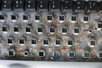 Dismantled PC keyboard with much garbage before cleaning