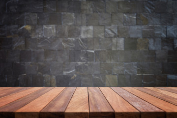 Empty top wooden table and stone wall background