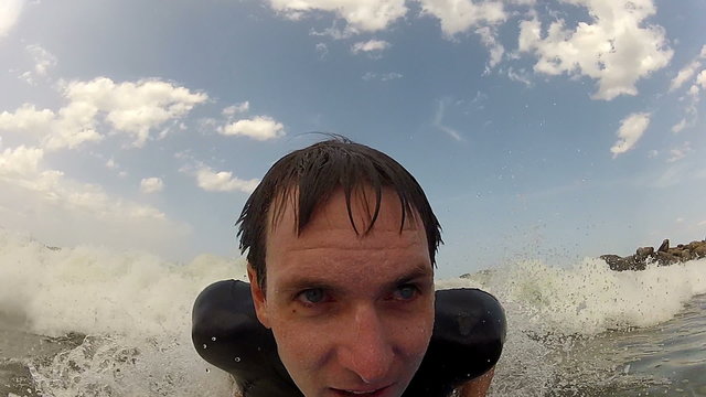 CLOSE UP: Young man bodyboarding