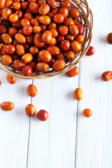 Ripe jujubes on blue wooden table, close up