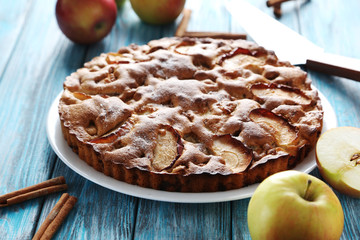 Homemade apple cake on blue wooden table