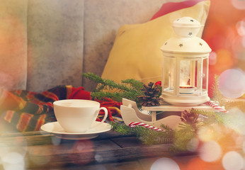 Still life interior details, cup of coffee, candles and Christma