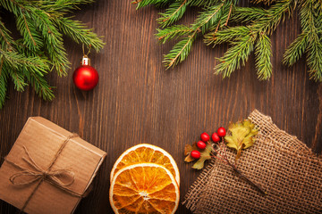 Christmas tree with gift box and decorations on wooden backgroun