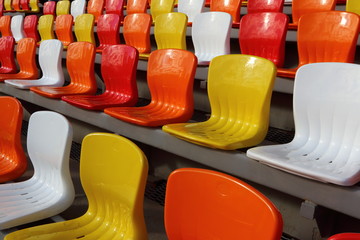 Color armchair rows of a modern stadium in the sunny day