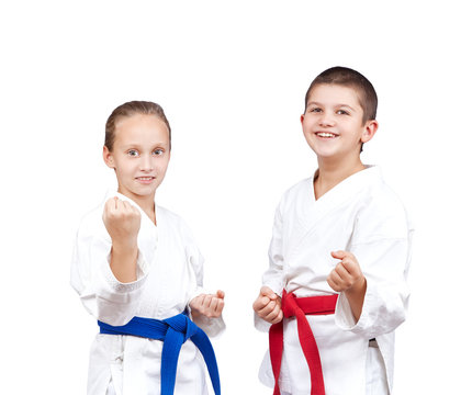 With red and blue belt the children stand in rack of karate