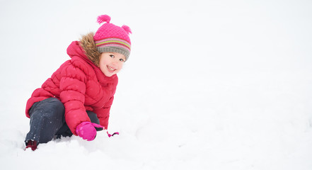 Happy child girl on a winter walk.