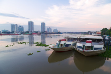 The restaurant cruise ships on Chao Phraya river and city scape in Bangkok, Thailand.