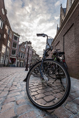 Fototapeta premium Red light district, Amsterdam, Netherlands. Vintage bikes parked on the street.