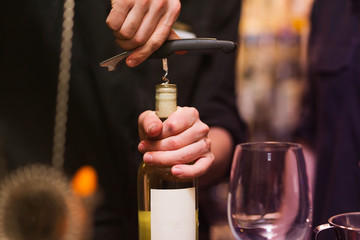 Opening a wine bottle with corkscrew  - Powered by Adobe