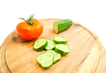 fresh cucumber and tomato on cutting board