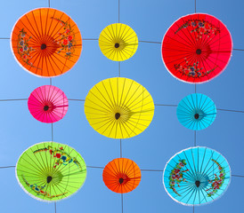  umbrellas hanging up with blue sky background
