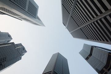 Fototapeta na wymiar Skyscrapers in Singapore viewed from the ground