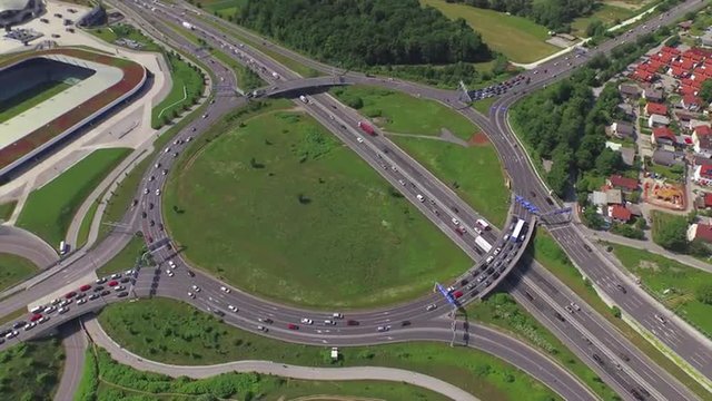 AERIAL TIMELAPSE: Busy traffic on highway roundabout in rush hour