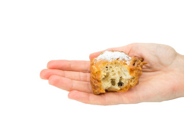 Hand palm showing partly eaten fritter or oliebol
