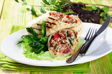 shawarma in pita bread on a plate small still-life green board restaurant beauty appetizing atmosphere