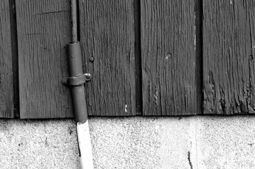 Black and white board wall background with pipe