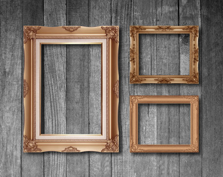 Old antique gold frame on wood texture background