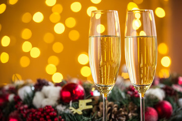 Two champagne glass on christmas bokeh background
