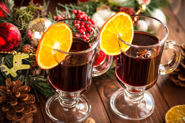Christmas hot mulled wine with spices on a wooden table. The idea for creating greeting cards