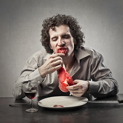 Disgusting man eating raw meat