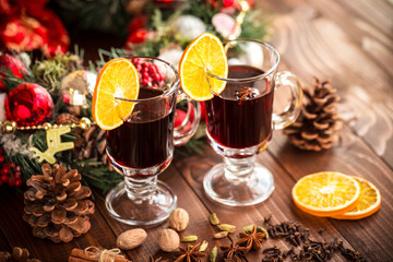 Obraz na płótnie Canvas Christmas hot mulled wine with spices on a wooden table. The idea for creating greeting cards