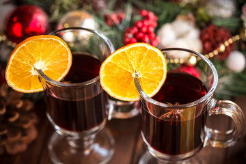 Christmas hot mulled wine with spices on a wooden table. The idea for creating greeting cards