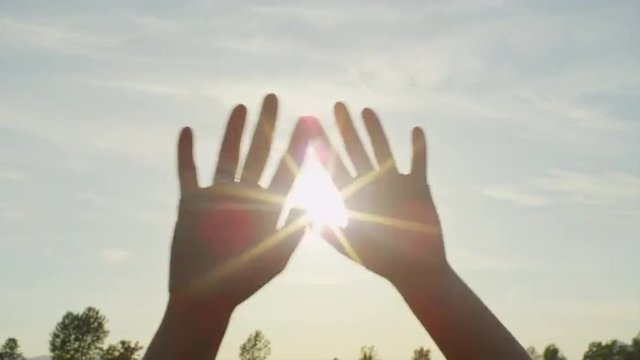 SLOW MOTION CLOSE UP: Hands waving over the sunny sky