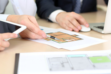 Real-estate agent discussing a  house plans with  a businessman.