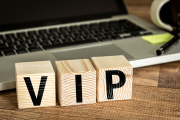 VIP written on a wooden cube in a office desk 
