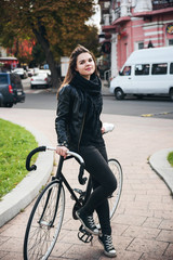 Fototapeta na wymiar young female riding a bicycle, girl with fixed gear bike