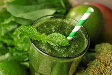 Green healthy juice with fruits and vegetables close up