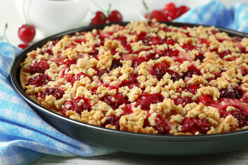Tasty homemade pie with cherries on table close up