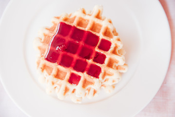 Golden waffles with jam
