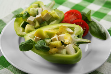 Fresh green salad in pepper on table close up