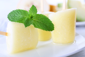 Melon ice lolly on table, closeup