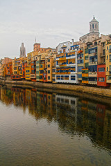 Fototapeta premium Reflections from houses in Onyar River, in Girona, one cloud day