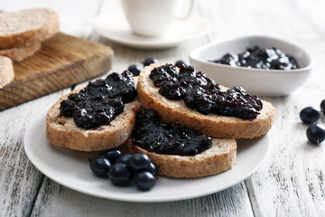 Fresh toast with butter and jam on table close up
