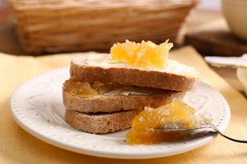 Fresh toast with butter and jam on table close up