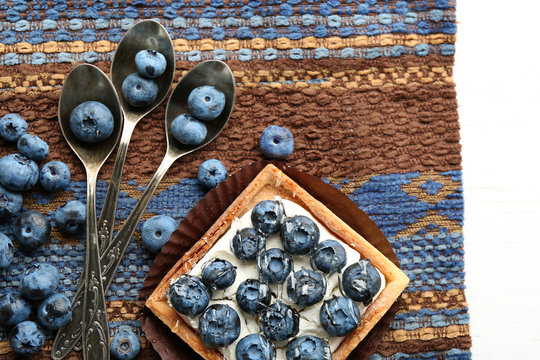 Gourmet fresh blueberry tart on napkin, close up