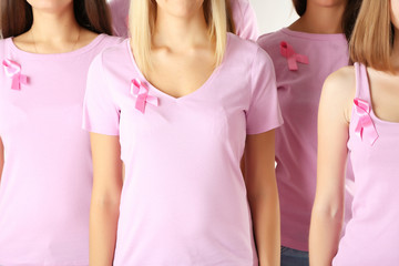 Women united with breast cancer awareness ribbon
