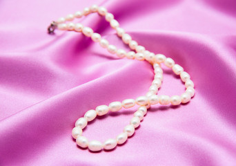 Pearls a necklace on a silk fabric